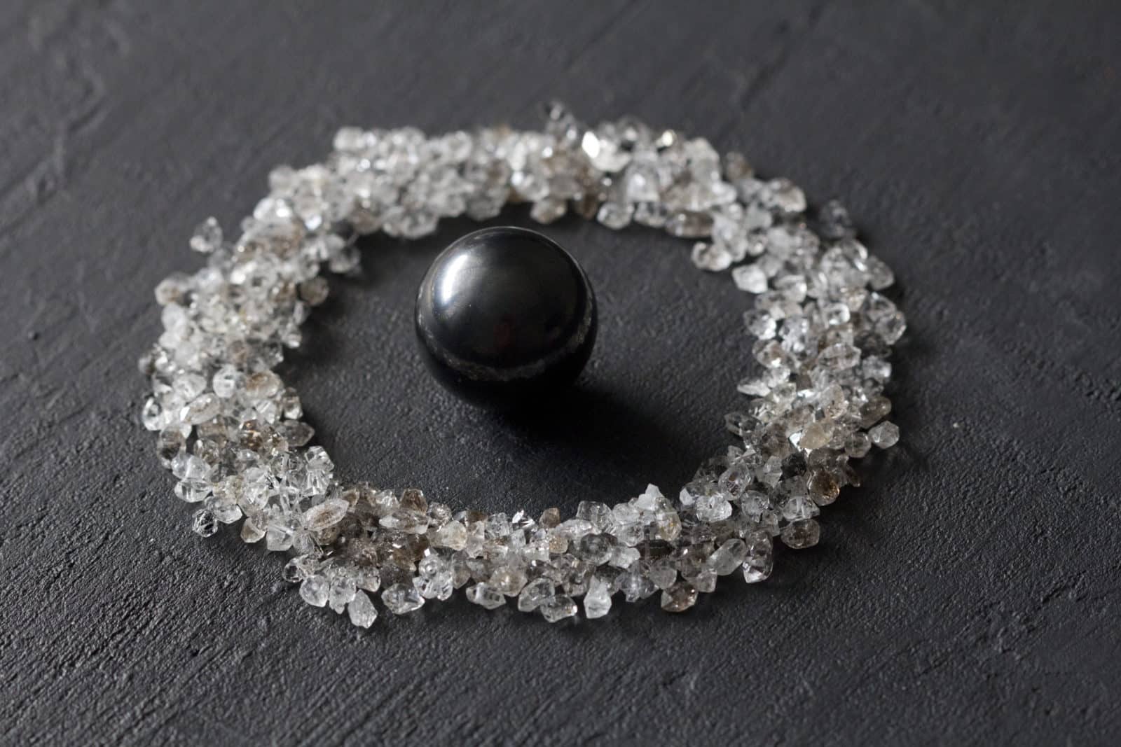 Scattered diamonds on a black background. Raw diamonds and mining, a